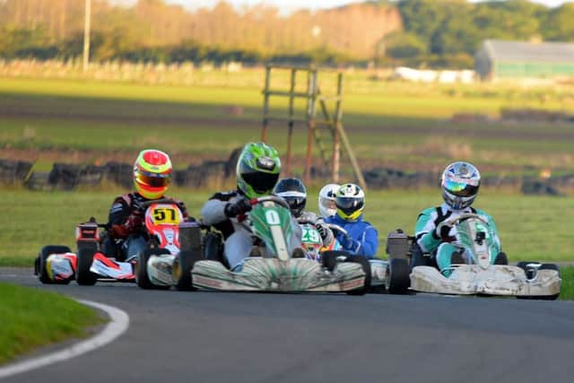 Jamie Draper (O) and Danien Mott (13) are wheel-to-wheel approaching Audreys Chicane with Market Rasens David Rendall (57) and Cadwells Dayle Hartley (29) tight behind. EMN-161114-101130002