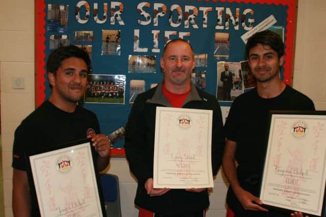 Instructor and fourth dan black belt Gary Stout (centre) with James (left) and Ben Etchell EMN-161114-131519002