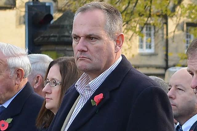 Mark Suffield (centre) at the Remembrance Sunday service. EMN-161114-162230001
