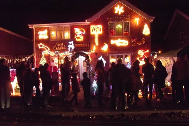Crowds outside the lights display at 89-91 Elmtree Road, Ruskington, on Monday. EMN-161121-095229001