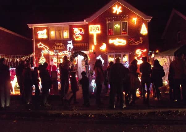 Crowds outside the lights display at 89-91 Elmtree Road, Ruskington, on Monday. EMN-161121-095229001