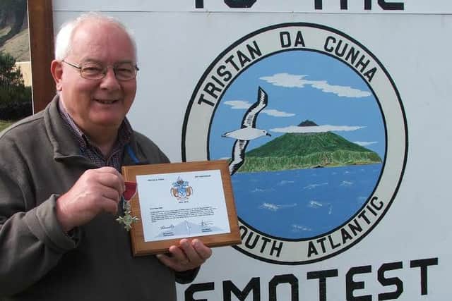 Chris with the plaque presented to him for his services to the island EMN-161117-104352001