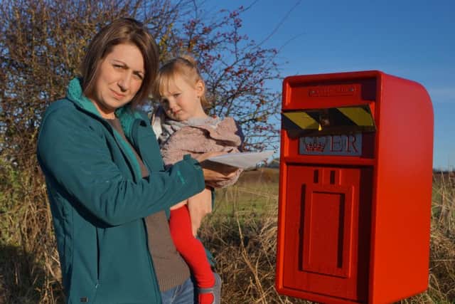 Laura and Honey Willoughby at the closed post box in Benniworth EMN-161126-202147001