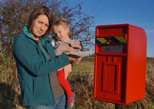 Laura and Honey Willoughby at the closed post box in Benniworth EMN-161126-202147001