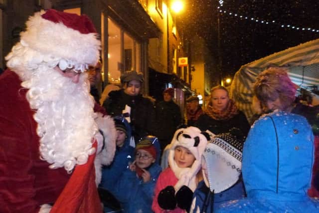 Children receiving chocolate coins from Santa at last year's event. EMN-161118-071106001