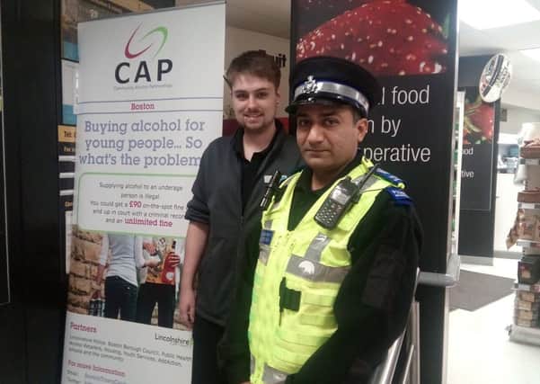 Co-operative Supervisor Thom Greatorex and PCSO Shreeji Brahmbahts with one of the CAP signs on display at the store on Wide Bargate.