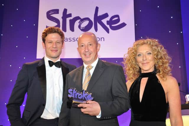 John Smejka receiving his award from actor James Norton and interior designer Kelly Hoppen. EMN-161119-114353001