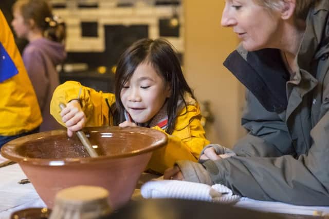 Youngsters can get stuck in stirring a Christmas pudding EMN-161122-170811001