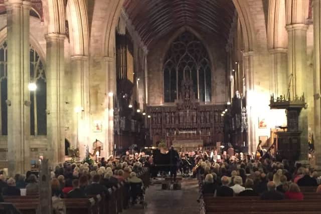 Boston Sinfonia performing at a busy concert EMN-161123-130717001