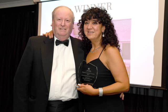 Bill Hutchinson, chairman of SECWHA, resents the Accommodation Award to Sue Raistrick of Carron House. Photo: MSKP-181116-73 ANL-161125-122141001