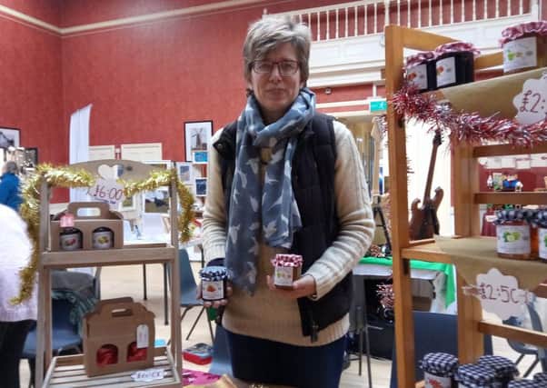 Sandra Scaman  with her Cottage Jams and Preserves at Alford Craft Market ANL-161126-163521001