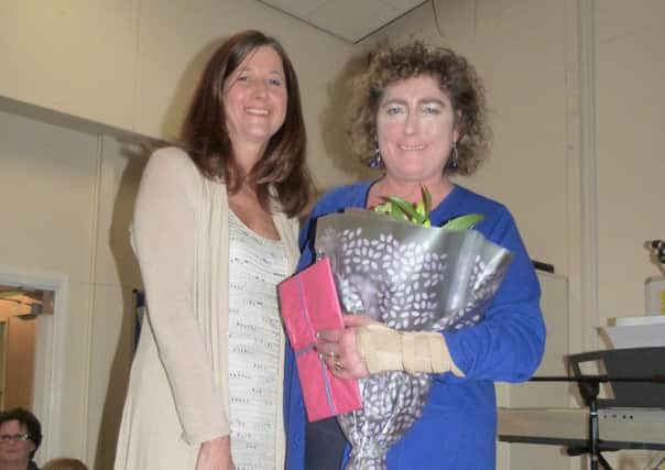 Anna Shepherd (left) presenting Angela Warmoth with flowers and gifts.  (Lin) EMN-160112-153935001