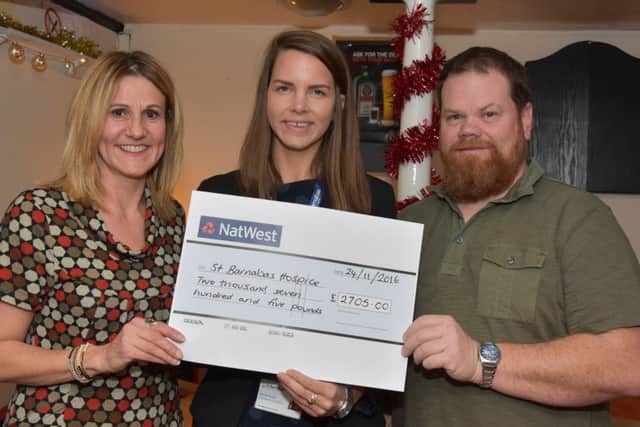 Julie Swift and Karl Fisher hand the cheque over to Harriet Hickin, community fundraiser for St Barnabas Lincolnshire Hospice. EMN-160512-062159001