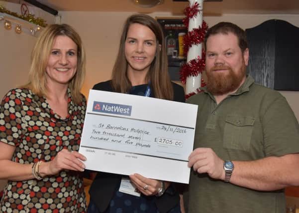 Julie Swift and Karl Fisher  hand the cheque over to Harriet Hickin, community fundraiser for St Barnabas Lincolnshire Hospice. EMN-160512-062159001
