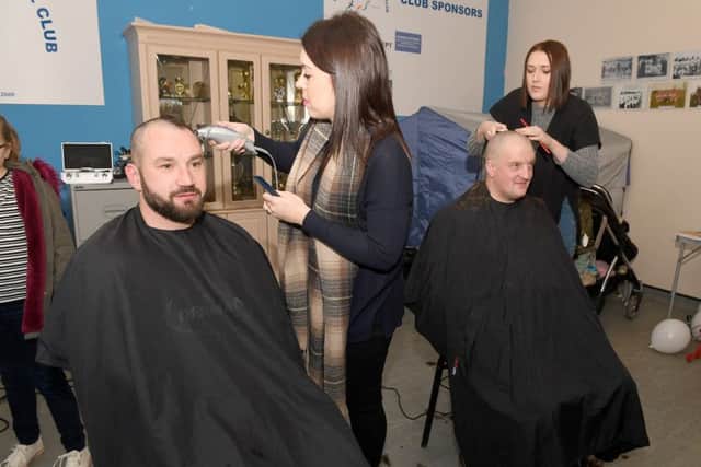Swineshead Institute Football Club players Robbie Masters and Simon Prue having their heads shaved EMN-160612-101849001