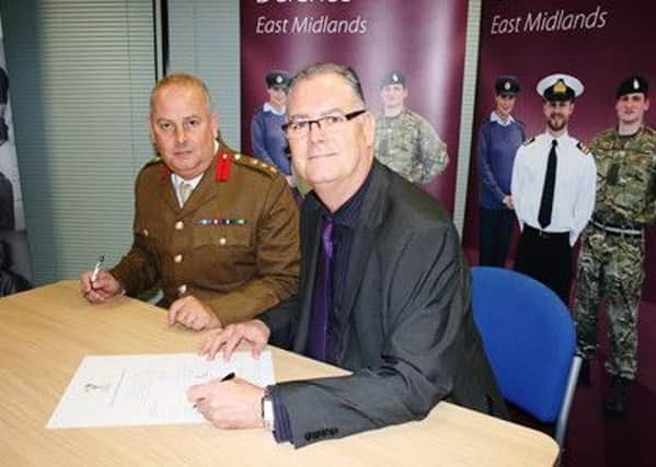 Colonel Niall MacDougall TD, Assistant Commander of the Grantham-based 102 Logistic Brigade and LPFT chairman Paul Devlin signing the Armed Forces Covenant. EMN-161129-141204001