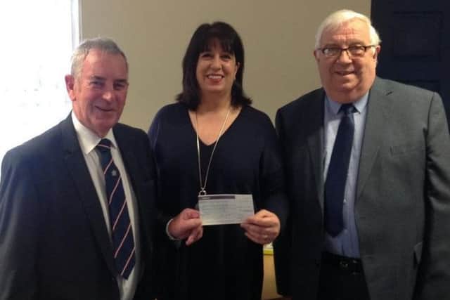 Worshipful Master of Bayons Lodge, Steve King, and charity steward Robert Murton presented the cheque to Elena Fraser-Green from the Lincoln and Lindsey Blind Society. EMN-160112-103320001