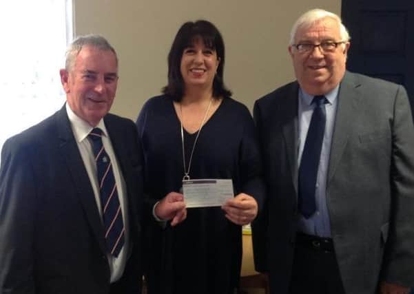 Worshipful Master of Bayons Lodge, Steve King, and charity steward Robert Murton presented the cheque to Elena Fraser-Green from the Lincoln and Lindsey Blind Society. EMN-160112-103320001