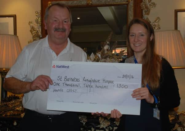 Retiring seniors captain Roger Culpin hands over his fundraising proceeds to Amy Reeve of St Barnabas Lincolnshire Hospice EMN-160212-085628002