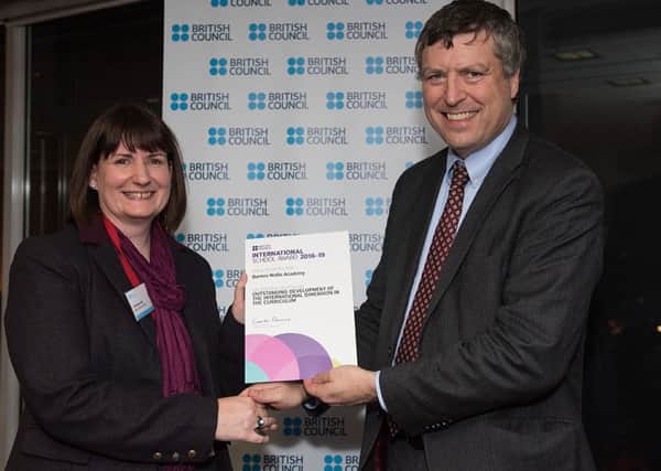 Barnes Wallis Academy's international coordinator Catherine Andy is presented with the International School Award by British Council CEO Sir Ciaran Davane