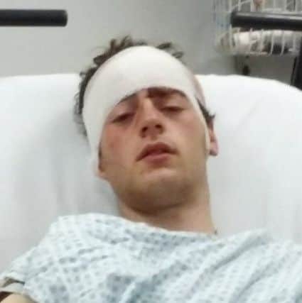 Harry Andrews in hospital after he was stabbed in the head.