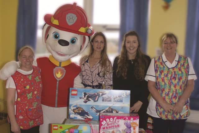 Marshall joined staff to give the children their treats EMN-160612-125603001