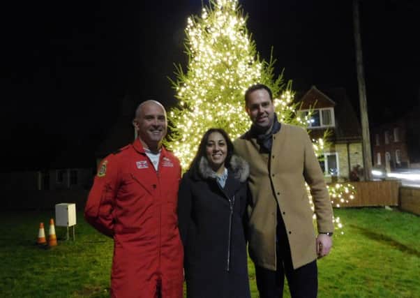 All lit up. @red 10' Squadron Leader Mike Ling with Navenby and Cliff Villages Business Network co-chairmen Mindy Arora and Luke Daniels at the Christmas shopping switch-on event. EMN-160912-141943001