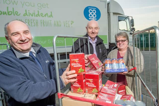 Lincolnshire Co-ops president Stuart Parker and Chief Retail Officer Mark Finn with Carol Rippin from the Salvation Army. ANL-160812-160245001