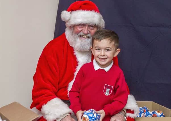 5-year-old Dillon Bonner was first to visit Santa at Coningsby School Xmas Fayre. Photo by Oscarpix Imaging. EMN-161212-074803001