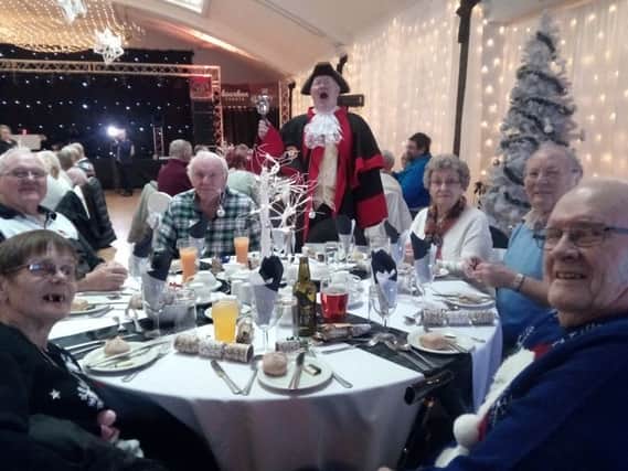 The town crier welcomes guests to one of the parties for the elderly being held at the Grosvenor House Hotel in Skegness. ANL-161212-135629001