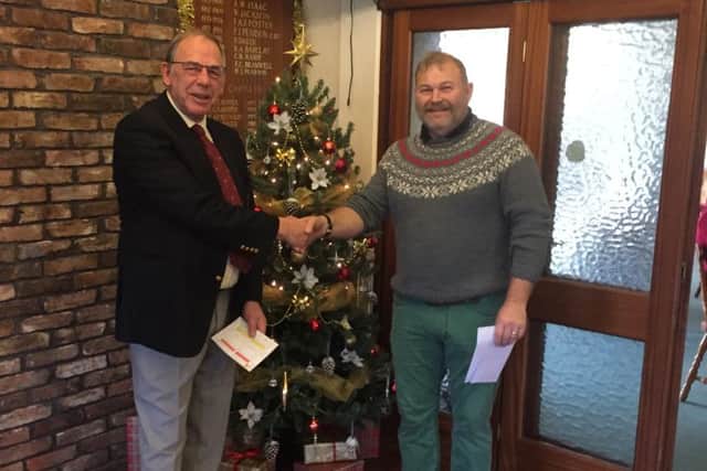 Mick Wood is seen collecting his prize from Captain Ray Sharpe.