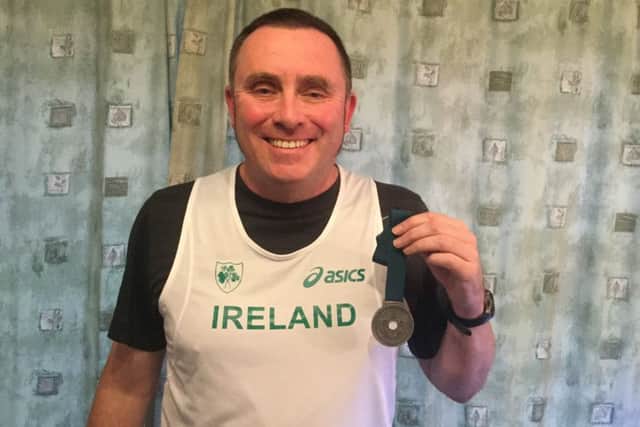 Jim Gillespie shows off his silver medal.