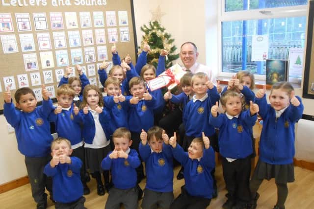 Headteacher Paul Fox celebrates the Ofsted report with pupils.