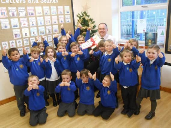 Headteacher Paul Fox celebrates the Ofsted report with pupils.