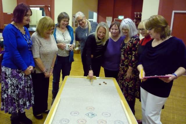 Members of Binbrook WI on the roll-a-penny game EMN-161222-093246001