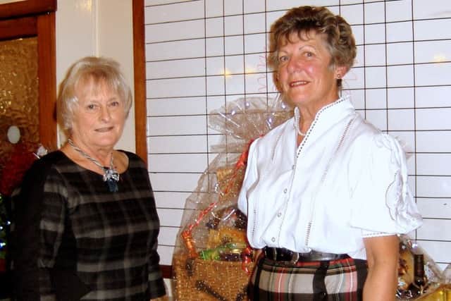 Liz Harris is seen receiving her hamper from Lady Captain Kath Yates.