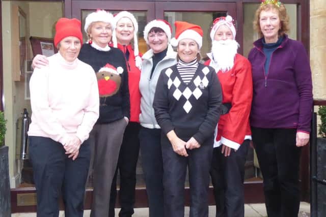 From left, Pam Westthorp, Patsy Clark, lady captain Andrea Smaggasgale, Sue Sykes, Father Christmas (AKA Allison Cook) and Rose Stevenson EMN-161219-122917002