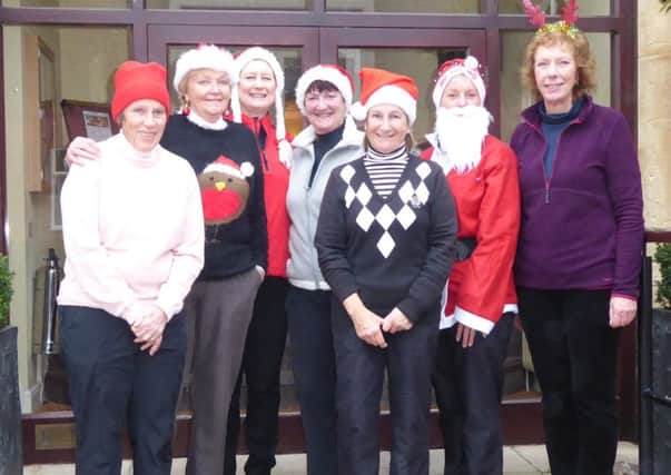 From left, Pam Westthorp, Patsy Clark, lady captain Andrea Smaggasgale, Sue Sykes, Father Christmas (AKA Allison Cook) and Rose Stevenson EMN-161219-122917002