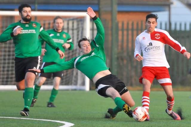 Sleaford Town Reserves defender Leigh Warman tackles Skegness's Luke Rayner-Mistry. Photo: Nigel West
