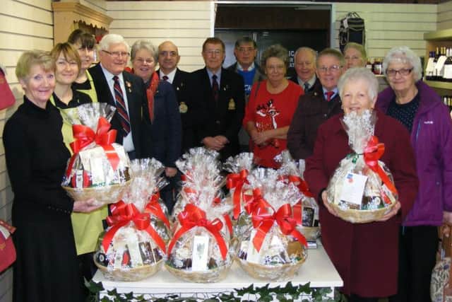 Royal British Legion members collect Christmas hampers from Four Seasons Garden Centre staff for house-bound members. EMN-161222-115131001