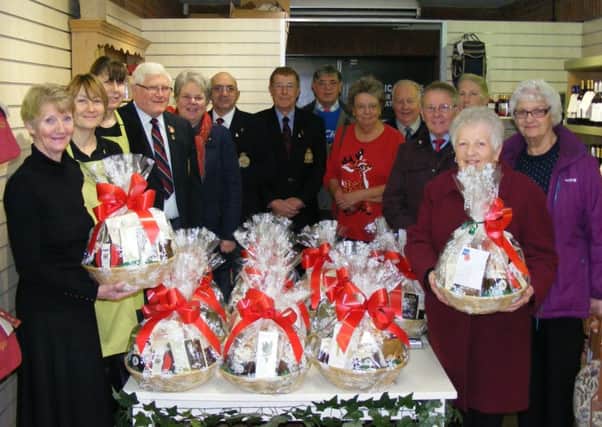 Royal British Legion members collect Christmas hampers from Four Seasons Garden Centre staff for house-bound members. EMN-161222-115131001