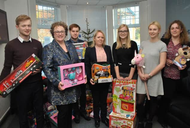Skegness Duncan and Toplis stafff Joe Smalley, director Michele Coe-Baxter, Daniel Plume, Sarah Holford, Lauren Bates, Hannah Buxton and Toni-Anne Bradley, who  delivered the toys. ANL-161220-145708001