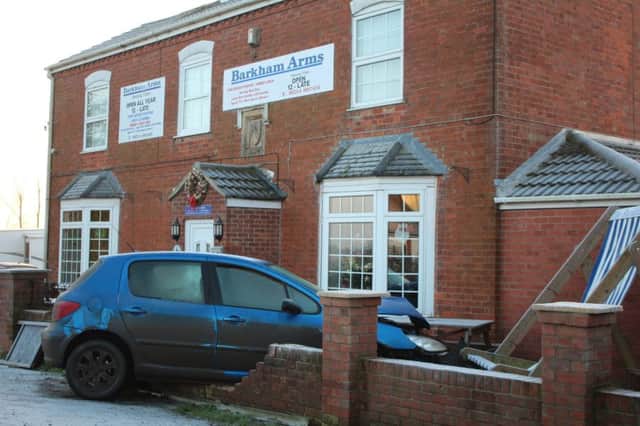 A car crashes through the wall of the Barkham Arms pub in Wainfleet St Mary. Photo: Stephen Willmer. ANL-161230-140914001