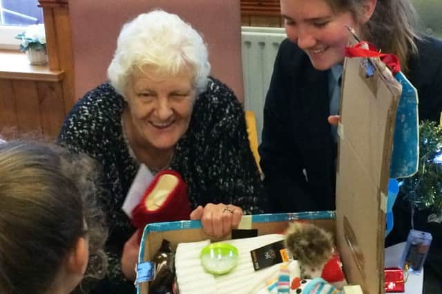 The presentation of one of the hampers made and filled by Queen Elizabeths Grammar in Alford.