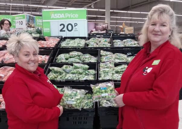 Asda store assistant Vanessa Jackson, who appears in the sprout video, with service section leader Jane Hayford and some of the veg being sold by the store.