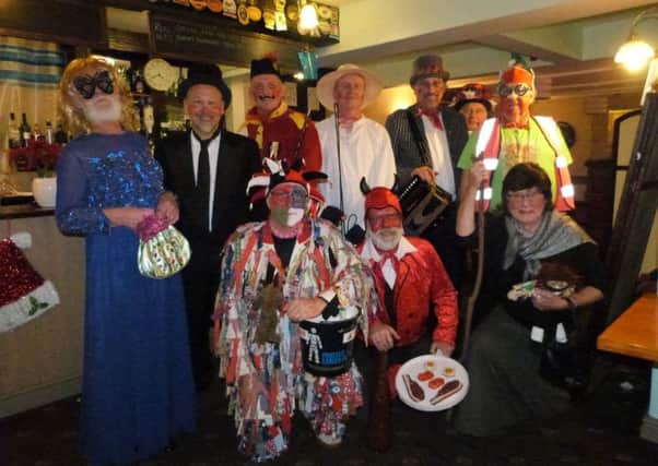The Grimsby Morris Men posing for the camera following their performance of the North Kelsey Plough Jags' Play.(photo by Linda Oxley) EMN-161227-120838001
