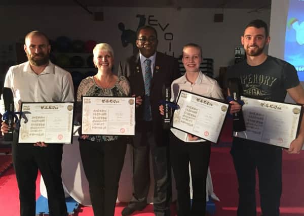 Black belts Kevin Hunter, Linda Baxter, Nesta Baxter and Benjamin Watson are pictured with Neville Wray (centre).