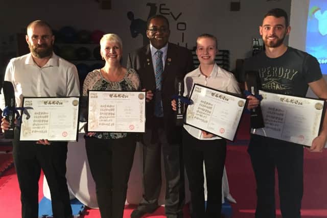 Black belts Kevin Hunter, Linda Baxter, Nesta Baxter and Benjamin Watson are pictured with Neville Wray (centre).