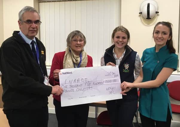 Air ambulance representatives Geoff and Anne Crawforth receive the cheque from Wragby Young Farmers members Alex Olivant and Charlotte Littleworth. EMN-161229-094620001