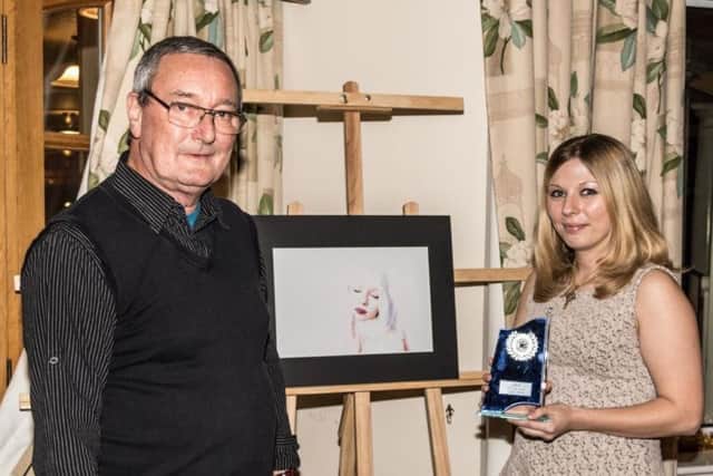 Skegness Camera Club member Cheryl Curtis with her winning photo is presented with her award by chairman Derek Snellgrove. ANL-170901-132316001